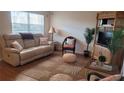 Comfortable living room with a plush sofa and tropical-themed decor at 300 Base E Ave # 123, Venice, FL 34285
