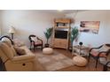 Bright living room featuring cozy seating and a wicker entertainment center at 300 Base E Ave # 123, Venice, FL 34285