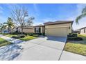 House exterior showcasing a tan elevation, two-car garage, and driveway at 368 Cedar Falls Dr, Apollo Beach, FL 33572