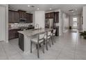 Charming kitchen features granite counters, stainless steel appliances, island with seating, and tile flooring at 11601 Parrotfish St, Venice, FL 34292