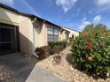 A charming single-story villa featuring mature landscaping with flowering shrubs at 1211 Capri Isle Blvd # 123, Venice, FL 34292