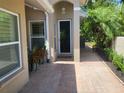 Inviting front entrance with brick paver walkway leading to a charming, light-filled home at 201 Auburn Woods Cir, Venice, FL 34292