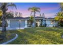Inviting single-story home featuring a two-car garage, well-maintained lawn and landscaped yard at 2899 Ensenada Ln, North Port, FL 34286
