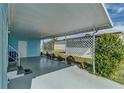 Spacious carport area offering covered parking and featuring a privacy screen at 356 Longwood Dr, Venice, FL 34285