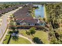 Aerial view of a home with screened-in pool and lake view at 5733 Semolino St, Nokomis, FL 34275