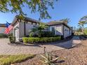 Charming exterior of a well-maintained home with manicured landscaping and a paver walkway at 5733 Semolino St, Nokomis, FL 34275