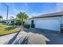 A single-story home featuring a spacious garage, lush landscaping, and a well-maintained lawn at 507 Foxwood Blvd # 4, Englewood, FL 34223