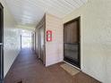 Hallway view with a fire extinguisher and multiple doors leading to individual units or storage at 654 Bird Bay E Dr # 206, Venice, FL 34285