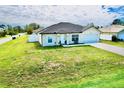 Well-maintained single-story home with a lush green lawn and an attached one car garage at 8307 Glover Ave, North Port, FL 34291