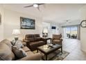 Inviting living room with tile floors, ceiling fan, and comfortable seating at 5800 Sabal Trace Dr # 501, North Port, FL 34287