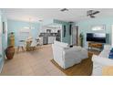 Inviting living room with comfortable seating, modern ceiling fan, and seamless flow to the kitchen and dining area at 1423 Avenida Del Circo # 1C, Venice, FL 34285