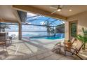 Stunning screened-in pool area featuring a waterfall and serene lake views, perfect for outdoor relaxation and entertainment at 400 Maraviya Blvd, Nokomis, FL 34275
