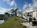 Inviting patio area overlooking a serene lake, perfect for outdoor dining and relaxation at 863 Baveno Dr, Venice, FL 34285