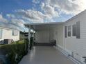 Covered carport providing ample parking space and protection from the elements at 863 Baveno Dr, Venice, FL 34285