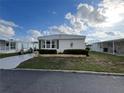 Well-maintained single-story home with manicured lawn and easy street access at 863 Baveno Dr, Venice, FL 34285