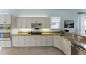 Bright kitchen featuring granite counters, stainless appliances, and classic white cabinetry at 11053 Barnsley Dr, Venice, FL 34293