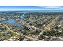 Panoramic aerial view of a waterfront community, showcasing the home's prime location near the water and neighborhood layout at 1985 Fairview Dr, Englewood, FL 34223