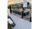 View of pontoon boat on dock with boat lift showing a 'Sweetwater' boat ready for Florida waters at 335 Englewood Isles Pkwy # 55, Englewood, FL 34223