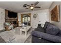 Inviting living room with whitewashed brick, fireplace, and neutral tones, offering a cozy and stylish space at 335 Englewood Isles Pkwy # 55, Englewood, FL 34223