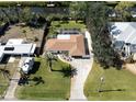 Aerial view of a beautiful waterfront property with a pool, lush landscaping, and private dock access at 809 Garland Ave, Nokomis, FL 34275