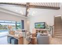 Cozy living room with a beamed ceiling, comfortable seating, and scenic views at 11571 Gleaming Ter, Venice, FL 34293