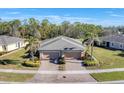 A tranquil community showcasing houses with brick driveways, mature trees, and lush lawns at 13542 Abercrombie Dr, Englewood, FL 34223