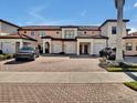 Charming condos featuring private garages and brick-paved driveways, complemented by neatly manicured landscaping at 23108 Banbury Way # 202, Venice, FL 34293