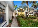 Charming home featuring a walkway, well-maintained landscaping, and views of neighboring homes at 237 Southampton Ln # 275, Venice, FL 34293