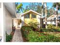 Inviting home entrance framed by vibrant landscaping and a well-lit walkway at 237 Southampton Ln # 275, Venice, FL 34293