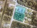 Aerial view of a property with a pool, surrounded by greenery in a residential neighborhood at 2737 Cottage Ln, North Port, FL 34286
