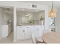 Bright, white kitchen overlooking the dining and living areas at 627 Alhambra Rd # 601, Venice, FL 34285