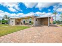 Charming single-story home featuring a brick driveway and covered carport, with water access and canal views at 6627 Marius Rd, North Port, FL 34287