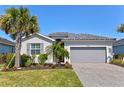 Charming single-story home with well-maintained lawn and mature palm trees at 14724 Ponce De Leon Trl, Port Charlotte, FL 33981