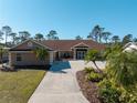 Beautiful single story home with mature landscaping and a long private driveway at 1611 Thomas St, Englewood, FL 34223