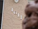 Close-up of the house number '1611' affixed to the textured exterior wall at 1611 Thomas St, Englewood, FL 34223