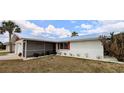 Cozy single-story house with red trim, a well-maintained lawn, and a screen door at 237 Venice East Blvd, Venice, FL 34293