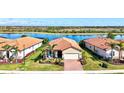 Beautiful single-story home with a lush lawn and picturesque water view at 10466 Medjool Dr, Venice, FL 34293