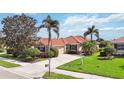 Charming single-story home boasting a well-maintained lawn, mature landscaping, and a private two-car garage at 133 Treviso Ct, North Venice, FL 34275