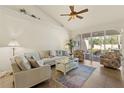 Bright living room with comfortable seating, neutral walls, and access to a screened-in patio, enhancing indoor-outdoor living at 1537 Monarch Dr, Venice, FL 34293