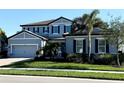 Charming two-story home with a two-car garage, lush lawn, and complemented by vibrant landscaping at 19836 Bridgetown Loop, Venice, FL 34293