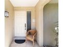 Close up of front door entrance with a chair and welcome mat at 407 Rubens Dr, Nokomis, FL 34275