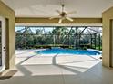 Covered pool with outdoor living area and ceiling fan at 408 Otter Creek Dr, Venice, FL 34292