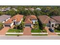 Aerial view of a neighborhood showcasing well-maintained lawns, mature trees, and tile roofs at 5665 Piccolo St, Nokomis, FL 34275