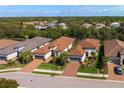 Neighborhood aerial view of the community showcasing mature landscaping, green lawns, and tile roofs at 5665 Piccolo St, Nokomis, FL 34275
