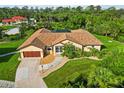 Charming home with beautiful landscaping, decorative stone pathway, and spacious driveway at 5694 Hale Rd, Venice, FL 34293