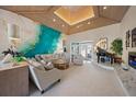 Spacious living room boasts vaulted ceilings, a striking accent wall, and a cozy seating area with a fireplace at 746 Eagle Point Dr, Venice, FL 34285