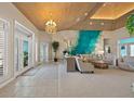Spacious living room with a decorative feature wall and wood paneled ceiling at 746 Eagle Point Dr, Venice, FL 34285