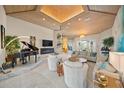 Elegant living room featuring a piano, fireplace, and comfortable seating at 746 Eagle Point Dr, Venice, FL 34285