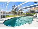 Inviting screened-in pool area featuring a sparkling pool and ample space for lounging and outdoor enjoyment at 888 Guild Dr, Venice, FL 34285