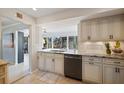 Bright kitchen featuring white cabinets, granite countertops and modern stainless steel appliances at 225 Randolph Rd, Venice, FL 34293